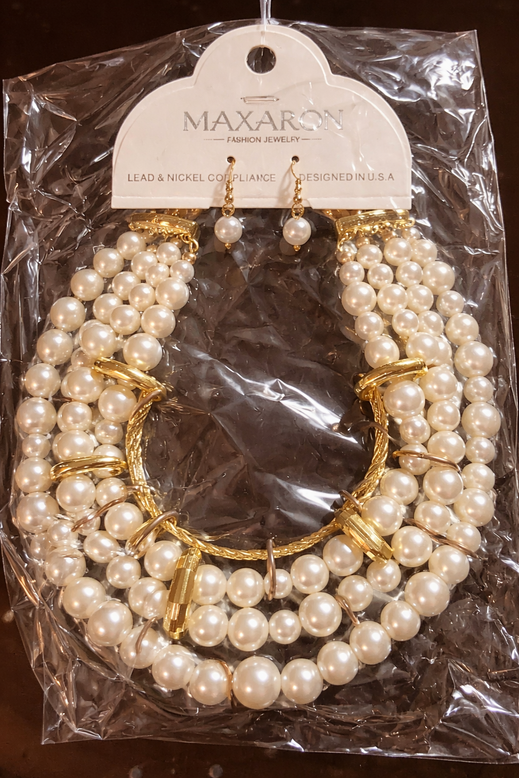 Pearl-inspired layered necklace and earring set with a bold multi-strand design and elegant gold-tone detailing.